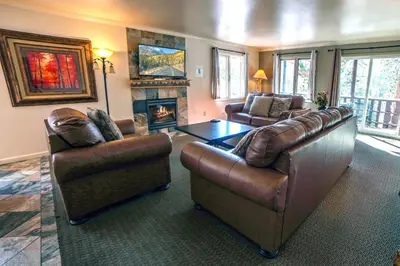 a living room with two couches and a fireplace at Fawn Valley Inn- 275 condo in Estes Park