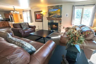 a living room with leather furniture and a fireplace at Fawn Valley Inn- 275 condo in Estes Park