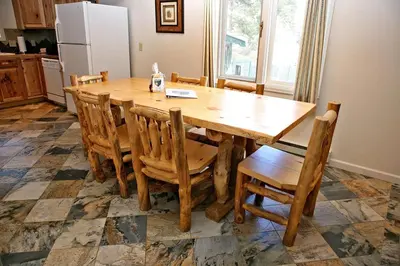 a kitchen with a wooden table and chairs at Fawn Valley Inn- 275 condo in Estes Park