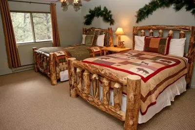 a bedroom with two beds and a window at Fawn Valley Inn- 275 condo in Estes Park