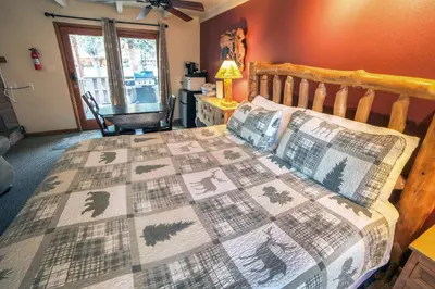 a bedroom with a bed with a quilt on it at Sunnyside Knoll- 12 apts in Estes Park