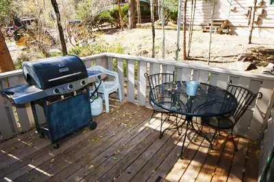 a grill and a table on a deck at Sunnyside Knoll- 12 apts in Estes Park