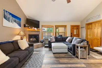 a living room with a couch and a fireplace at 24 Snake River Village Townhomes condo in Keystone