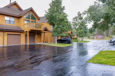 a driveway in front of a house in the rain at 24 Snake River Village Townhomes condo in Keystone