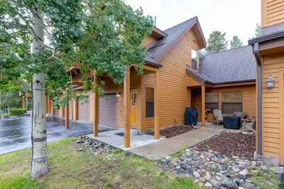 a wooden house with a porch and a yard at 24 Snake River Village Townhomes condo in Keystone