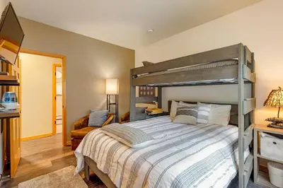 a bedroom with a large bed and a desk at 24 Snake River Village Townhomes condo in Keystone