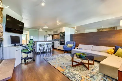 a living room with a couch and a table at Winter Park Condo with Private Balcony Near Skiing! in Winter Park
