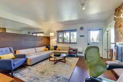 a living room with a couch and a table at Winter Park Condo with Private Balcony Near Skiing! in Winter Park