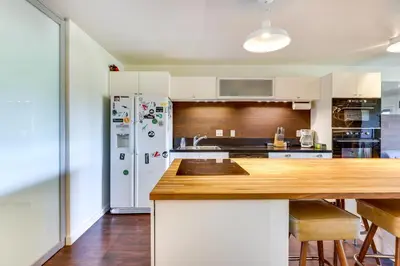 a kitchen with a white refrigerator and a wooden counter top at Winter Park Condo with Private Balcony Near Skiing! in Winter Park