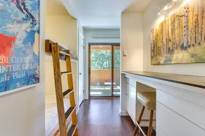 a home office with a desk and a ladder at Winter Park Condo with Private Balcony Near Skiing! in Winter Park