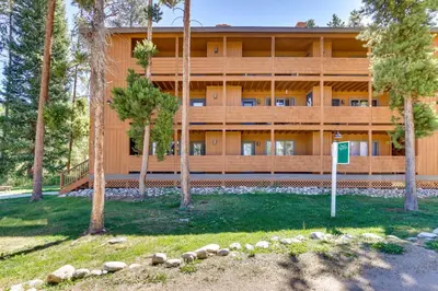 a large building with trees in front of it at Winter Park Condo with Private Balcony Near Skiing! in Winter Park