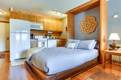a bedroom with a bed and a kitchen at 2 Mi to Granby Ranch Granby Vacation Rental! in Granby
