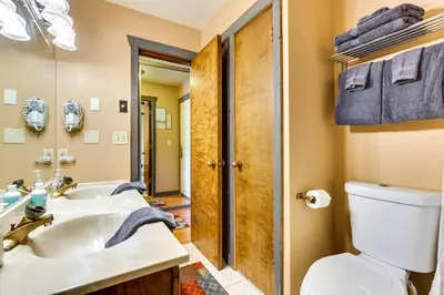 a bathroom with a white sink and a toilet at 2 Mi to Granby Ranch Granby Vacation Rental! in Granby