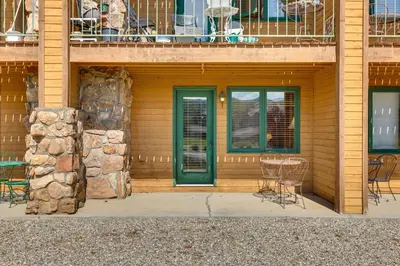 a house with green doors and a table and chairs at 2 Mi to Granby Ranch Granby Vacation Rental! in Granby