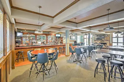 a restaurant with tables and chairs and a bar at 2 Mi to Granby Ranch Granby Vacation Rental! in Granby