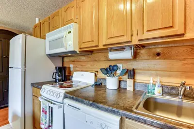 a kitchen with a white refrigerator and a sink at 2 Mi to Granby Ranch Granby Vacation Rental! in Granby
