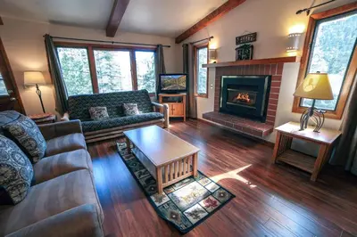 a living room with a couch and a fireplace at Sunnyside Knoll- 17 cabin in Estes Park