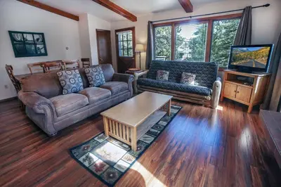 a living room with a couch and a coffee table at Sunnyside Knoll- 17 cabin in Estes Park