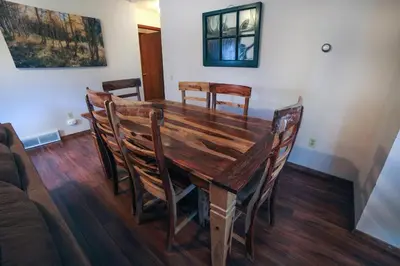 a wooden dining room table with chairs around it at Sunnyside Knoll- 17 cabin in Estes Park