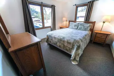 a small bedroom with a bed and a window at Sunnyside Knoll- 17 cabin in Estes Park