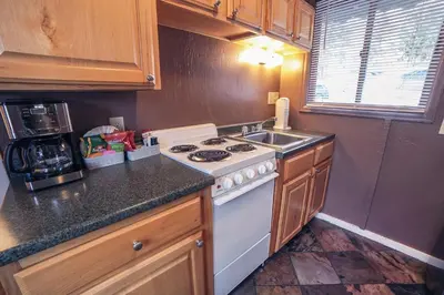 a kitchen with a white stove and a sink at Fawn Valley Inn- Cabana apts in Estes Park
