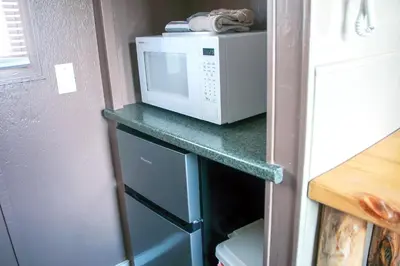 a microwave sitting on top of a counter in a kitchen at Fawn Valley Inn- Cabana apts in Estes Park