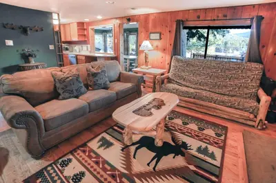 a living room with a couch and a table at Lazy R Cottages- 9 cabin in Estes Park