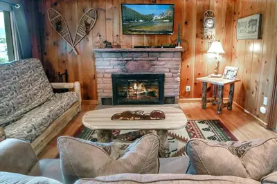 a living room with a couch and a fireplace at Lazy R Cottages- 9 cabin in Estes Park