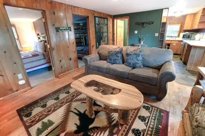a living room with a couch and a coffee table at Lazy R Cottages- 9 cabin in Estes Park