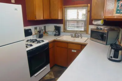 a small kitchen with a stove and a sink at Lazy R Cottages- 9 cabin in Estes Park