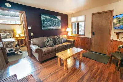 a living room with a couch and a coffee table at Sunnyside Knoll- 5 cabin in Estes Park