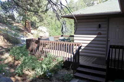a porch of a house with a wooden fence at Sunnyside Knoll- 7 cabin in Estes Park
