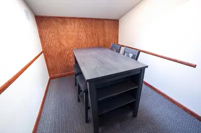 a small room with a wooden table and chairs at Sunnyside Knoll- 7 cabin in Estes Park