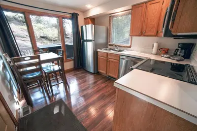a kitchen with a refrigerator and a counter top at Sunnyside Knoll- 7 cabin in Estes Park