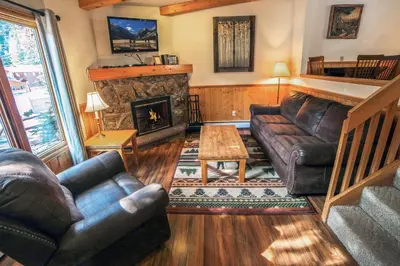 a living room with a couch and a fireplace at Sunnyside Knoll- 8 cabin in Estes Park