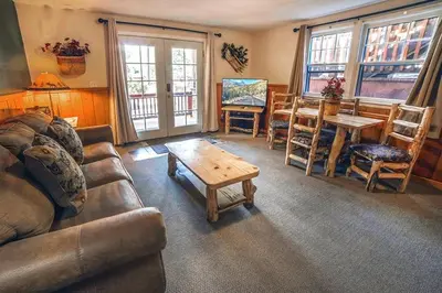 a living room with a couch and a table and chairs at Lawn Lane A - #3382 in Estes Park