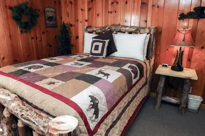 a bedroom with a bed in a log cabin at Lawn Lane A - #3382 in Estes Park