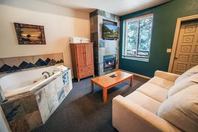 a living room with a couch and a bath tub at Fawn Valley Inn- 104 condo in Estes Park