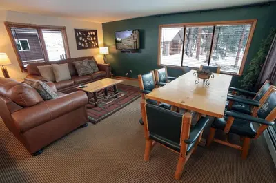 a living room with a couch and a table at Timber Creek Chalets- 14 chalet in Estes Park