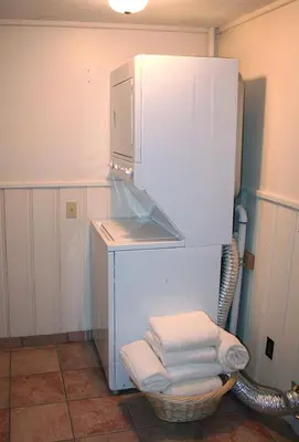 a refrigerator in a kitchen with a basket of towels at Timber Creek Chalets- 14 chalet in Estes Park
