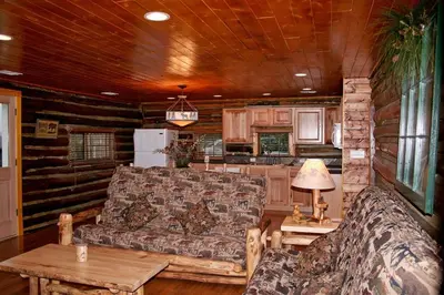 a living room with a couch and a table at Triple R Cottages- 8 cabin in Estes Park