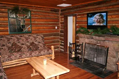 a living room with a couch and a fireplace at Triple R Cottages- 8 cabin in Estes Park