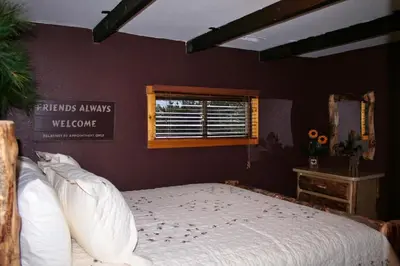 a bedroom with a bed and a window at Triple R Cottages- 8 cabin in Estes Park