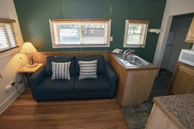 a blue couch in a kitchen with a sink at Triple R Cottages- 2 cabin in Estes Park
