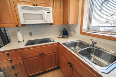 a kitchen with a sink and a microwave at Sunnyside Knoll- 9 cabin in Estes Park