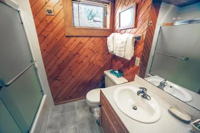 a bathroom with a sink and a toilet and a mirror at Sunnyside Knoll- 9 cabin in Estes Park