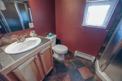 a bathroom with a sink and a toilet at Lazy R Cottages- 16A cabin in Estes Park