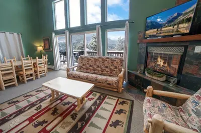 a living room with a fireplace and a tv at Lazy R Cottages- 16A cabin in Estes Park