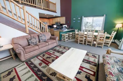 a living room with a couch and a table at Lazy R Cottages- 16A cabin in Estes Park
