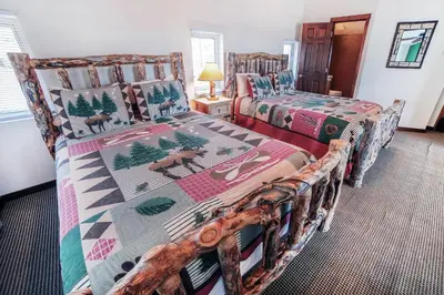 a bedroom with two beds in a room at Lazy R Cottages- 16A cabin in Estes Park